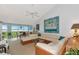 Living area features sectional sofa and panoramic water views at 1341 Perico Point Cir # 116, Bradenton, FL 34209