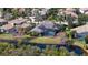 Aerial view of house with pool and canal-front lot at 13616 Legends Walk Ter, Lakewood Ranch, FL 34202