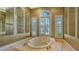 Bathroom with soaking tub and glass shelves at 13616 Legends Walk Ter, Lakewood Ranch, FL 34202