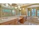 Elegant bathroom featuring double sinks, a soaking tub and a glass shower at 13616 Legends Walk Ter, Lakewood Ranch, FL 34202