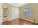 Well-lit bedroom with hardwood floors and a double door closet at 13616 Legends Walk Ter, Lakewood Ranch, FL 34202