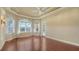 Bright bedroom featuring hardwood floors and a window with plantation shutters at 13616 Legends Walk Ter, Lakewood Ranch, FL 34202