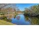 Tranquil canal-front view with lush vegetation and reflections at 13616 Legends Walk Ter, Lakewood Ranch, FL 34202