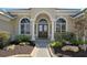 Elegant entryway with arched doorway and columns at 13616 Legends Walk Ter, Lakewood Ranch, FL 34202