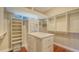 Large walk-in closet with ample shelving and drawers at 13616 Legends Walk Ter, Lakewood Ranch, FL 34202