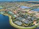 Aerial view of community tennis courts and lake at 13925 Miranese St, Venice, FL 34293