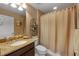 Bathroom with granite countertop, shower, and toilet at 13925 Miranese St, Venice, FL 34293