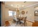 Elegant dining room with chandelier and hardwood floors at 13925 Miranese St, Venice, FL 34293