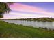 Tranquil lake view with homes along the shoreline at 13925 Miranese St, Venice, FL 34293