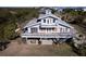 Elevated view of waterfront home showcasing large deck and private parking at 145 Burns Rd, Terra Ceia, FL 34250