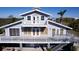 Elevated view of waterfront home showcasing large deck and private parking at 145 Burns Rd, Terra Ceia, FL 34250