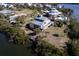 Aerial view of waterfront home with private dock and surrounding landscape at 145 Burns Rd, Terra Ceia, FL 34250