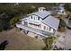 Elevated view of waterfront home showcasing large deck and private parking at 145 Burns Rd, Terra Ceia, FL 34250