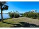 Spacious backyard with grassy area, offering tranquil views of the waterfront at 145 Burns Rd, Terra Ceia, FL 34250