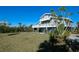 Two-story house exterior showcasing a large deck and waterfront views at 145 Burns Rd, Terra Ceia, FL 34250