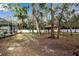 Expansive backyard with gazebo, stone path, and mature trees at 14802 7Th E Ave, Bradenton, FL 34212