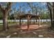 Landscaped backyard with gazebo and fire pit at 14802 7Th E Ave, Bradenton, FL 34212