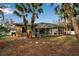 Large backyard with pool and screened enclosure, palm trees, and stone path at 14802 7Th E Ave, Bradenton, FL 34212