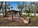 Backyard with gazebo, fire pit, and wooden seating at 14802 7Th E Ave, Bradenton, FL 34212