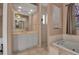 Elegant bathroom with shower, tub and double sinks at 14802 7Th E Ave, Bradenton, FL 34212