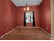 Cozy dining area with red walls, carpeting, and a chandelier at 14802 7Th E Ave, Bradenton, FL 34212