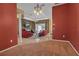 View of a spacious dining room with red walls and carpeting at 14802 7Th E Ave, Bradenton, FL 34212