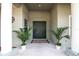 Front entry with double doors, columns, and potted plants at 14802 7Th E Ave, Bradenton, FL 34212