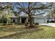 Single-story house with green exterior, attached garage, and landscaping at 14802 7Th E Ave, Bradenton, FL 34212