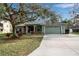 Single-story house with green exterior, attached garage, and landscaping at 14802 7Th E Ave, Bradenton, FL 34212