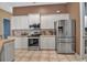 Modern kitchen with stainless steel appliances and white cabinets at 14802 7Th E Ave, Bradenton, FL 34212