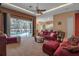 Living room with red couches, a large TV, and pool view at 14802 7Th E Ave, Bradenton, FL 34212