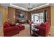 Spacious living room with red couches and a wood-paneled accent wall at 14802 7Th E Ave, Bradenton, FL 34212