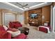 Living room with red couches, wood wall, and a large TV at 14802 7Th E Ave, Bradenton, FL 34212