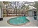 Kidney-shaped pool with screened enclosure and backyard view at 14802 7Th E Ave, Bradenton, FL 34212