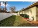 Landscaped side yard with white fence and pool equipment at 14802 7Th E Ave, Bradenton, FL 34212