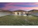 Serene backyard at dusk, featuring a patio and grassy area at 15304 Miller Creek Dr, Sun City Center, FL 33573