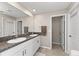 Double vanity bathroom with granite countertops and neutral color scheme at 15304 Miller Creek Dr, Sun City Center, FL 33573