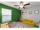 bedroom with playful decor and a yellow couch at 15304 Miller Creek Dr, Sun City Center, FL 33573