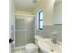 Small bathroom with grey tile, shower and single vanity at 1625 Bravo Dr, Clearwater, FL 33764