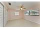 Spacious bedroom with light pink walls and ceiling fan at 1625 Bravo Dr, Clearwater, FL 33764