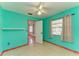 Bright bedroom with teal walls, window, and ceiling fan at 1625 Bravo Dr, Clearwater, FL 33764