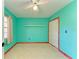 Teal bedroom with wood trim, ceiling fan and built-in closet at 1625 Bravo Dr, Clearwater, FL 33764