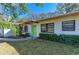 House exterior with a green door and landscaping at 1625 Bravo Dr, Clearwater, FL 33764