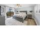 Spacious bedroom with a gray platform bed and fluffy rug at 1649 Manor Rd, Englewood, FL 34223