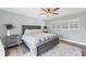 Serene bedroom with gray platform bed and white plantation shutters at 1649 Manor Rd, Englewood, FL 34223