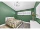 Charming bedroom with green walls and patterned bedding at 1649 Manor Rd, Englewood, FL 34223