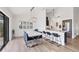 Bright dining room featuring a white table and blue chairs at 1649 Manor Rd, Englewood, FL 34223