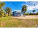 House exterior showcasing a metal roof and paver driveway at 1649 Manor Rd, Englewood, FL 34223