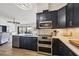 Modern kitchen with stainless steel appliances and dark cabinetry at 1649 Manor Rd, Englewood, FL 34223