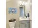 Well-appointed powder room with gray vanity and updated fixtures at 16625 5Th E Ave, Bradenton, FL 34212